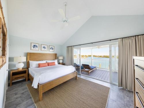 a bedroom with a bed and a balcony at Villas at Hawks Cay Resort in Duck Key