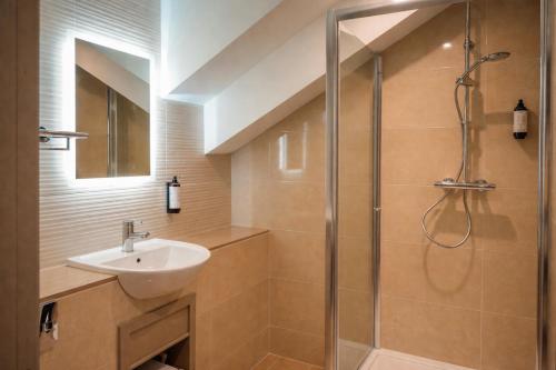 a bathroom with a shower and a sink at Hotel Rue in Omagh