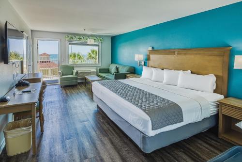 a hotel room with a bed and a desk at The Islander Inn in Ocean Isle Beach