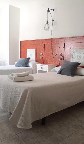 a large bed in a room with two beds at Pension Casa Curro in Palas de Rei