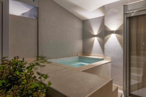 a bathroom with a hot tub in the corner at The HostMaster 910 Loft in Piraeus