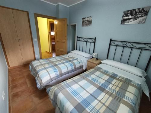 a room with two beds in a room at Casa Rural Javier in Valmuel