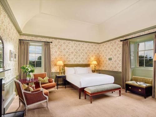 a hotel room with a bed and a chair at Carton House A Fairmont Managed hotel in Maynooth