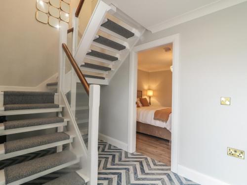 a hallway with stairs leading to a bedroom at Portnablagh Cottage in Dunfanaghy