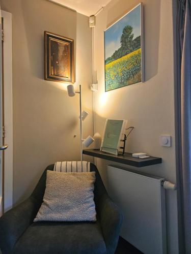 a room with a couch and a desk with a laptop at Artz of Nature in Emmen