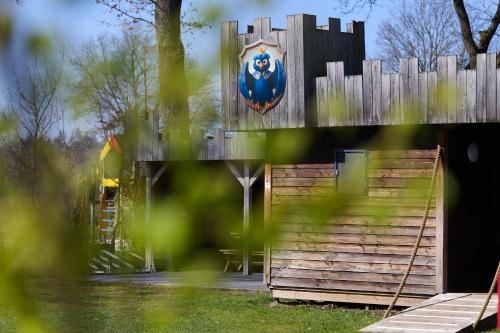 a wooden fence with a sign on it at Castle Uylenburght | 10 persons in Rheeze