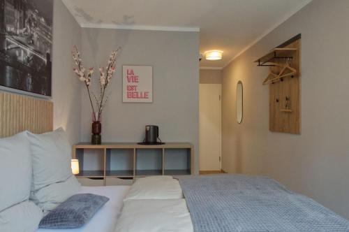 a bedroom with a bed and a vase on a table at Wohnen bei FrauSchmitt in Bad König