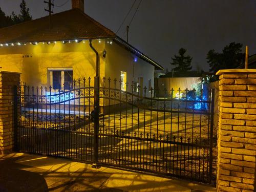 a gate to a house with lights on it at Anita in Budapest