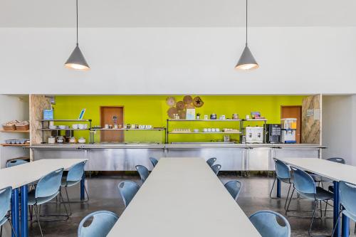 a cafeteria with tables and chairs and a counter at HI Viana do Castelo - Pousada de Juventude in Viana do Castelo