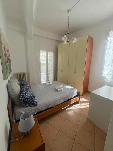 a bedroom with a bed and a cabinet in it at Appartamento Centrale - sulla pedonale in Dolceacqua