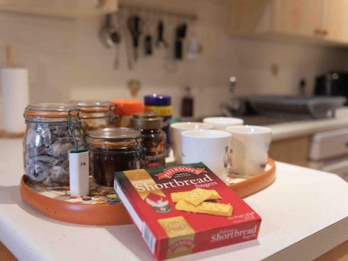 a counter with a box of crackers and a box of food at Steading Cottage - Ukc5957 in Port Appin