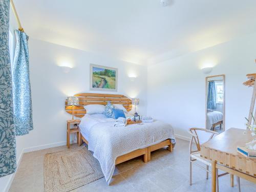 a bedroom with a bed and a table in a room at Swallow - Uk50155 in Faversham