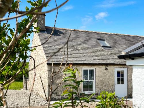 a stone cottage with a gray roof at Landberrick Farm Bothy 1 in Mochrum