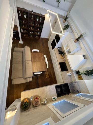 an overhead view of a living room with a couch and a table at DEA DREAMS - Lofty Marghera in Milan