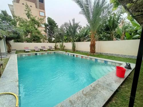 a swimming pool in the backyard of a house at Villa Set ma'at Nile view in Luxor