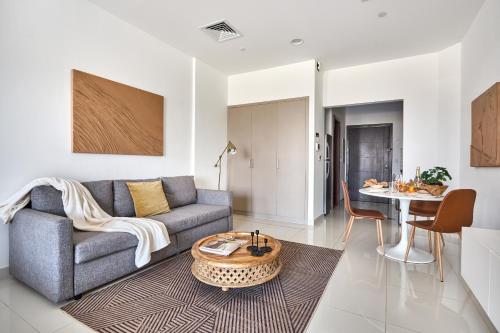 a living room with a couch and a table at Frank Porter - Canal Residence in Dubai