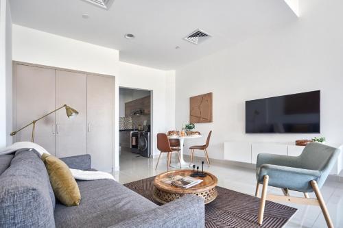 a living room with a couch and a table at Frank Porter - Canal Residence in Dubai