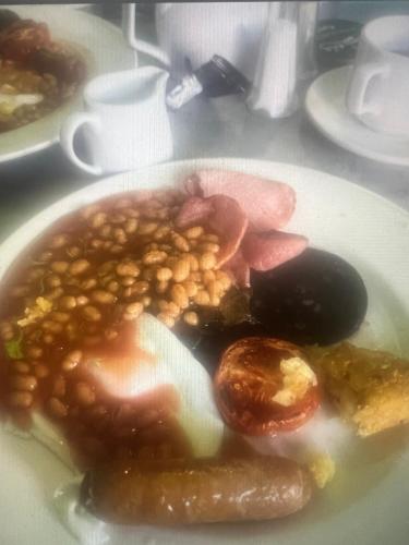 a plate of food with beans on a table at The B & B Blackpool in Blackpool