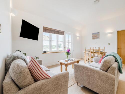 a living room with two couches and a tv at Wren - Uk50152 in Stalisfield