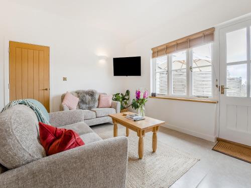 a living room with two couches and a table at Wren - Uk50152 in Stalisfield