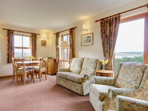 a living room with a couch and a chair and a table at Moy in Taynish