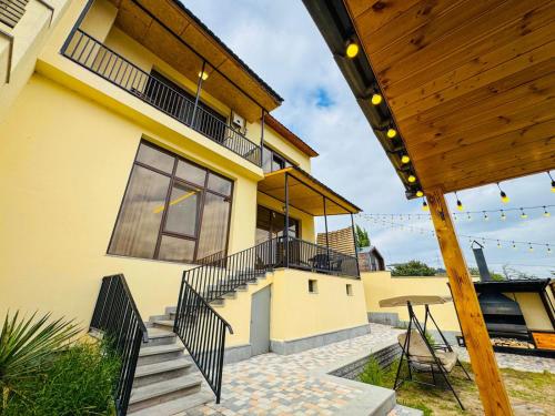 a house with a staircase and a balcony at Miracle View Dilijan in Dilijan