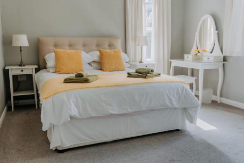 a bedroom with a bed with two towels on it at Charming St Davids Cottage with Cathedral Views in St. Davids