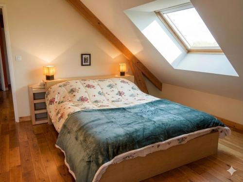 a bedroom with a bed in a attic at Parfums des peintres proche Crozant - Chambres d'hôtes in Villard