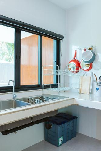 a kitchen with a sink and a window at Chaba Pool Villa Khao Lak in Khao Lak
