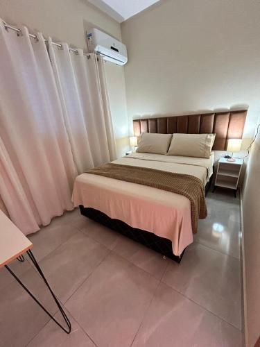 a bedroom with a large bed in a room at Casa, Delfinópolis - Serra da Canastra, MG in Delfinópolis