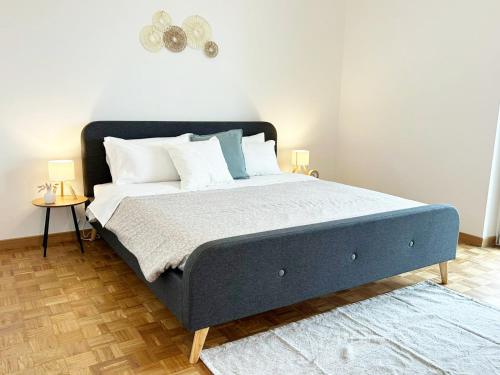 a bedroom with a bed with a blue bed frame at Quick Home Belvedere Masserano in Masserano