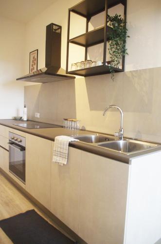 a kitchen with a sink and a counter top at Quick Home Belvedere Masserano in Masserano