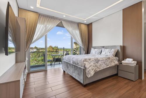 a bedroom with a bed and a balcony at Luxury House with Private Pool for Gathering in Davao City