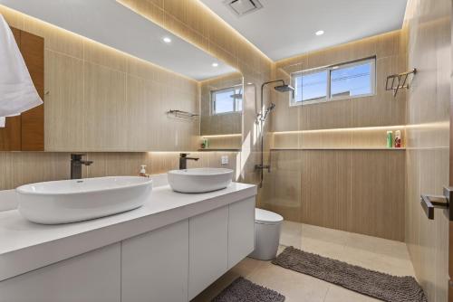 a bathroom with two sinks and a toilet at Luxury House with Private Pool for Gathering in Davao City