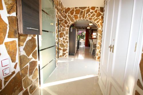 a hallway of a house with a stone wall at Villa Brownies in Els Poblets