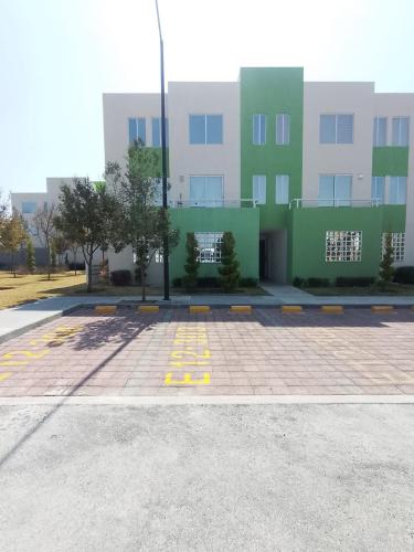 an empty parking lot in front of a building at DePA DRAGON in Tizayuca