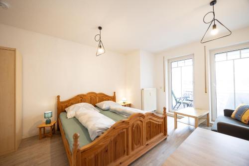 a bedroom with a wooden bed in a room at Appartement Denis in Chemnitz