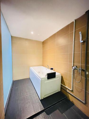 a bathroom with a white sink and a shower at Melaka City Hotel in Malacca
