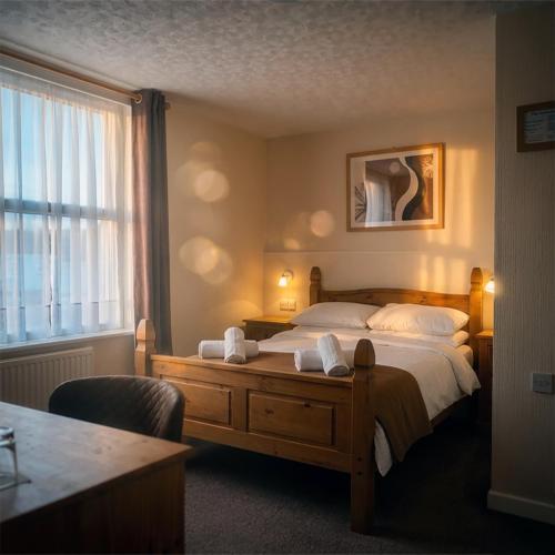 a hotel room with a bed and a window at Trevellis Bed and Breakfast in Newquay