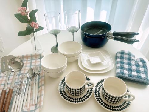 a table with cups and plates and a pot on it at Hi Seoul Gongdeok 2 in Seoul
