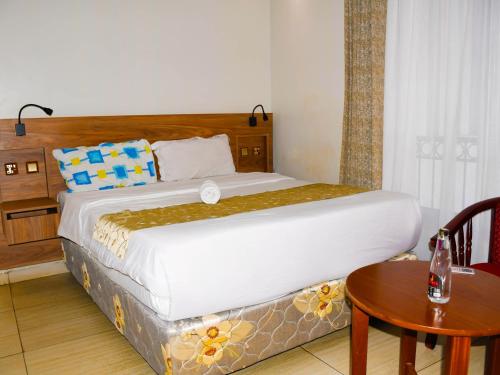 a bedroom with a bed and a table with a table at Decale Jewel Stone Hotel in Nairobi
