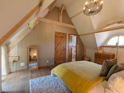 a bedroom with a large bed and a large window at Ty Bras - 8000 m² de jardin in Camors