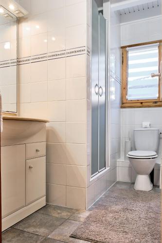 a bathroom with a toilet and a glass shower at Chalet Solariale in La Teste-de-Buch