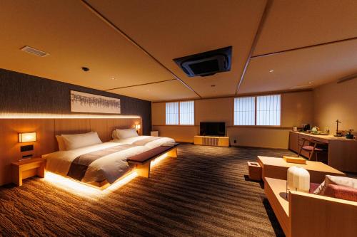 a bedroom with a bed and a tv in it at 奈良春日 鹿のや in Nara