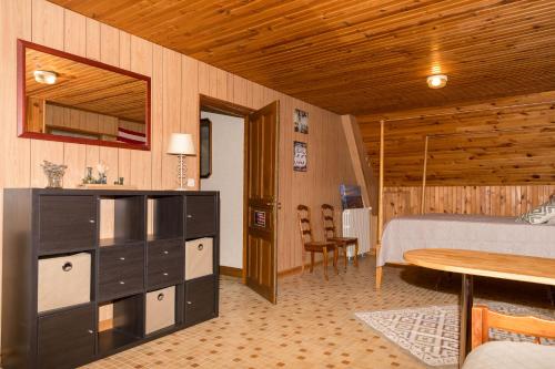a bedroom with a bed and a desk and a table at La maison du pont du gué in Bourgueil