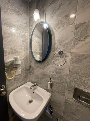 a bathroom with a sink and a mirror at New Taksim Hotel in Istanbul