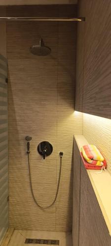 a bathroom with a shower with a shower head at Villa AM in Awlād ‘Umar