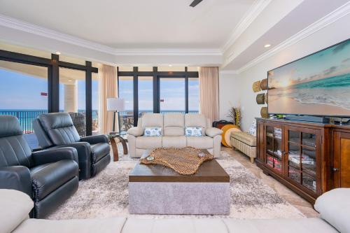 a living room with a large flat screen tv at The Oasis 411 formerly Phoenix West II 411 in Orange Beach