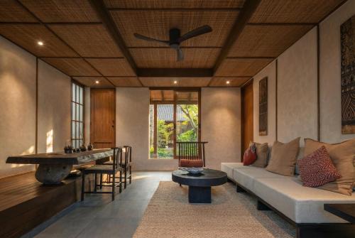 a living room with a couch and a table at SHIBUMI - Private Pool & Spa Boutique Villa in Ubud