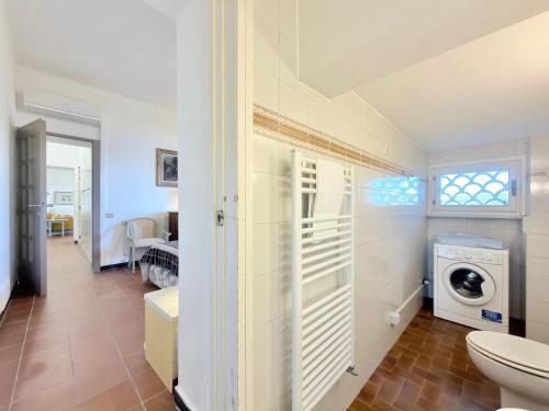 a bathroom with a washer and dryer in a room at VILLA TRAMONTO in Levanto